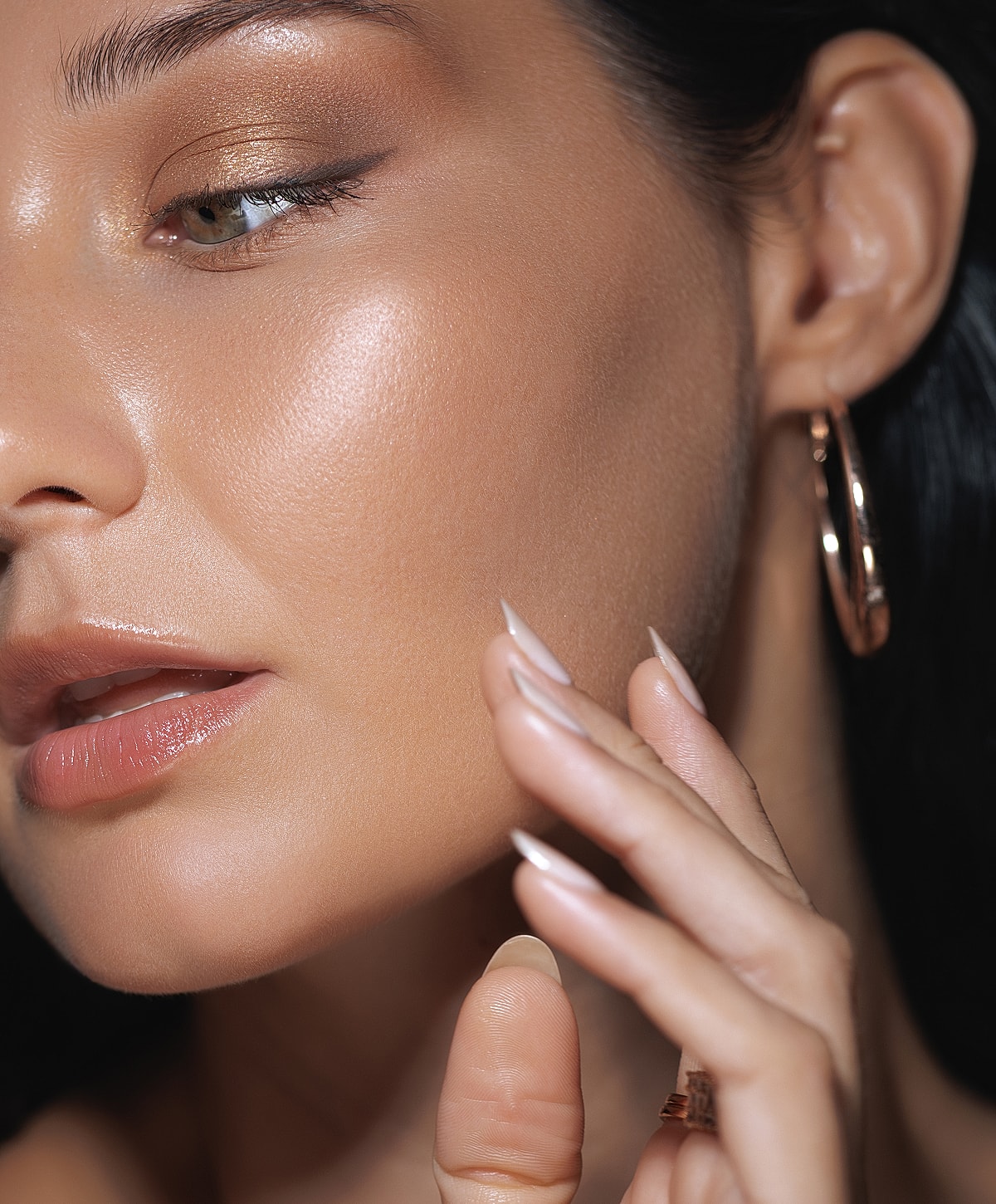 Model posing with hands raised and closed eyes.