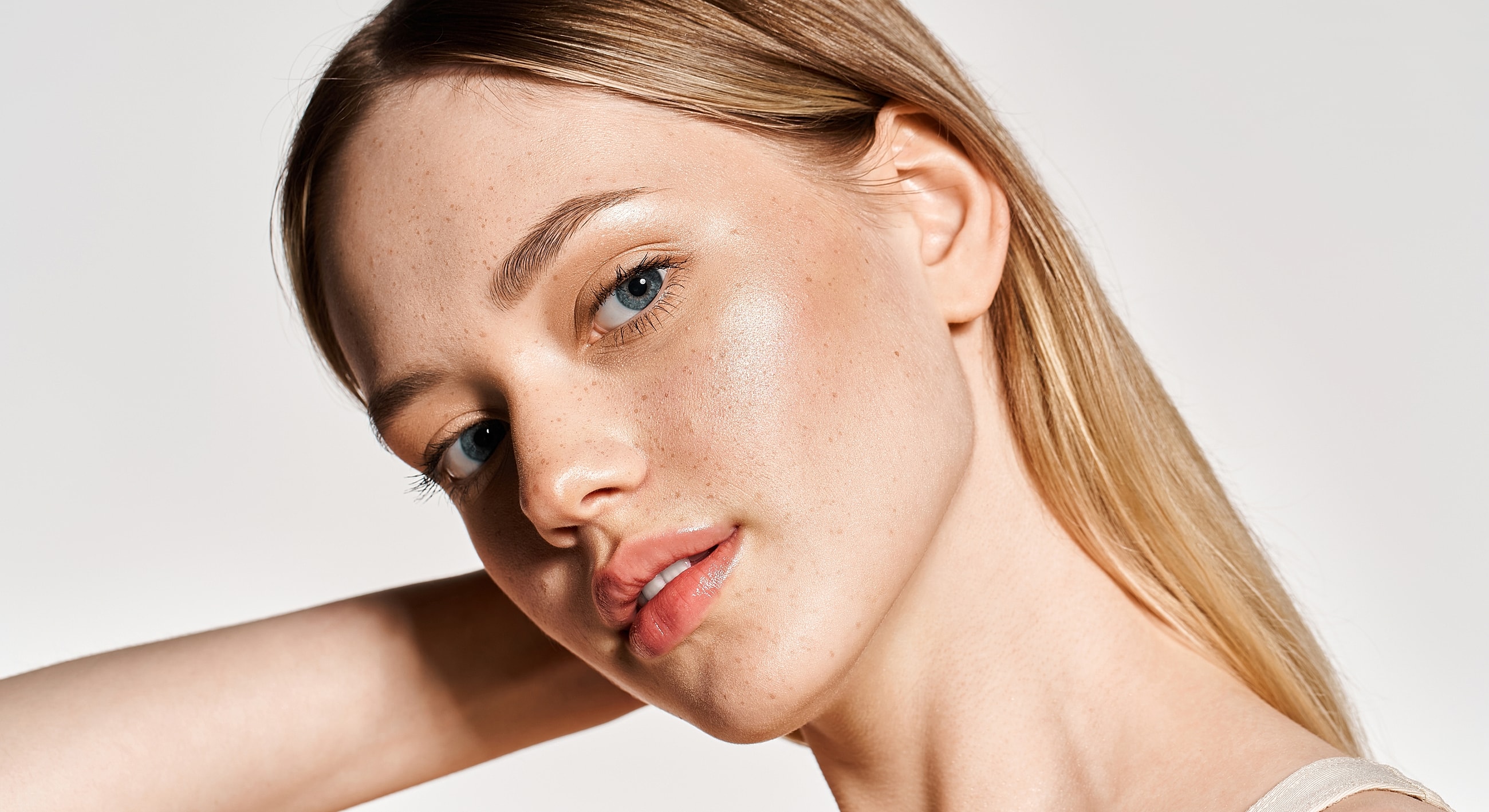 Close-up portrait of a woman with flawless skin.